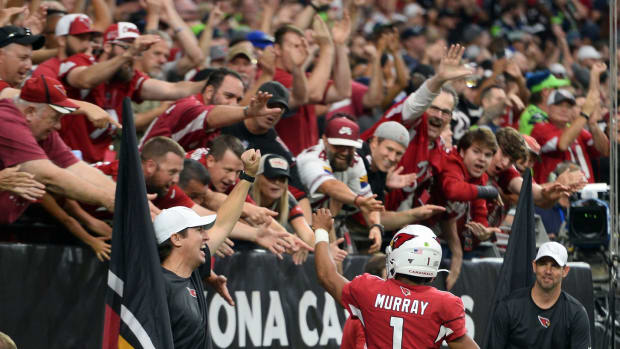 Arizona Cardinals quarterback Kyler Murray (1) celebrates a touchdown with fans during the second half of the game against the Seattle Seahawks at State Farm Stadium.